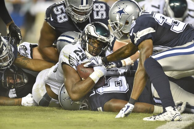 Sep 20, 2015; Philadelphia, PA, USA; Philadelphia Eagles running back DeMarco Murray looks at the line judge as Dallas Cowboys defensive tackle Jack Crawford tackles him in the fourth quarter at Lincoln Financial Field. Mandatory Credit: James Lang-USA TODAY Sports