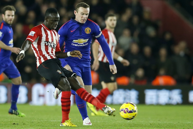 Southampton’s Victor Wanyama, left, is challenged for the ball by Manchester United’s Wayne Rooney during their English Premier League soccer match between Southampton and Manchester United at St Mary's stadium in Southampton, England, Monday, Dec. 8, 2014. (AP Photo/Alastair Grant)