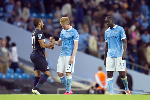 Manchester City's Kevin De Bruyne, centre, shakes hands with West Ham United's Dimitri Payet as Yaya Toure looks on after the English Premier League soccer match between Manchester City and West Ham United at the Etihad Stadium, Manchester, England, Saturday Sept. 19, 2015. (AP Photo/Jon Super)
