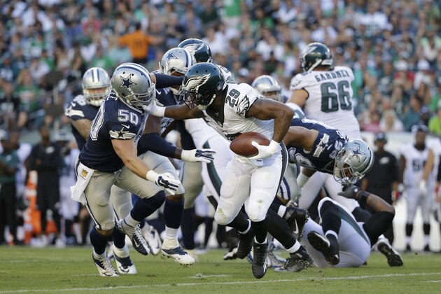 Philadelphia Eagles' DeMarco Murray (29) tries to keep Dallas Cowboys' Sean Lee (50) at bay during the first half of an NFL football game, Sunday, Sept. 20, 2015, in Philadelphia. (AP Photo/Matt Rourke)