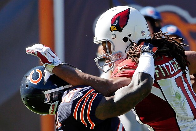 CHICAGO, IL - SEPTEMBER 20: Larry Fitzgerald #11 of the Arizona Cardinals stiff arms Antrel Rolle #26 of the Chicago Bears as he rushes for a touchdown during the fourth quarter at Soldier Field on September 20, 2015 in Chicago, Illinois.  (Photo by Jon Durr/Getty Images)