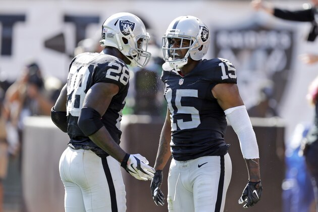 Oakland Raiders' Michael Crabtree (15) celebrates his touchdown reception with teammate Latavius Murray (28) during the third quarter of an NFL football game, Sunday, Sept. 20, 2015, in Oakland , Calif. (AP Photo/Ben Margot)