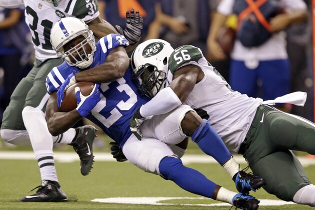 New York Jets inside linebacker Demario Davis (56) tackles Indianapolis Colts running back Frank Gore (23) in the first half of an NFL football game in Indianapolis, Monday, Sept. 21, 2015.  (AP Photo/Darron Cummings)
