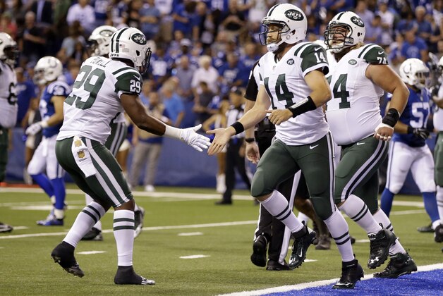New York Jets quarterback Ryan Fitzpatrick (14) is congratulated by running back Bilal Powell (29) after thrown a touchdown pass against the Indianapolis Colts  in the first half of an NFL football game in Indianapolis, Monday, Sept. 21, 2015.  (AP Photo/Darron Cummings)