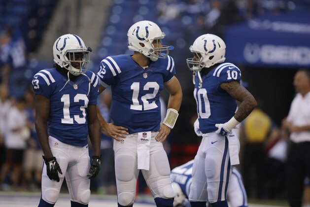 Indianapolis Colts quarterback Andrew Luck, center, talks with receiver T.Y. Hilton, left, and Donte Moncrief before an NFL football game against the Tennessee Titans in Indianapolis, Sunday, Sept. 28, 2014. (AP Photo/Darron Cummings)