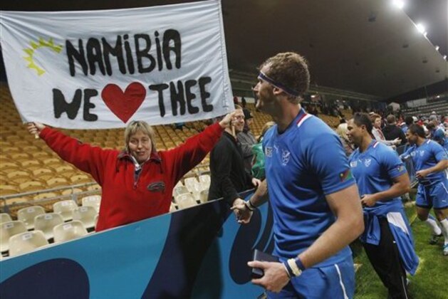 A Namibian supporter holds up a banner as the players shake hands with the crowd following their 81-7 loss to Wales in their Rugby World Cup game at Stadium Taranaki in New Plymouth, New Zealand, Monday, Sept. 26, 2011. (AP Photo/Dita Alangkara)