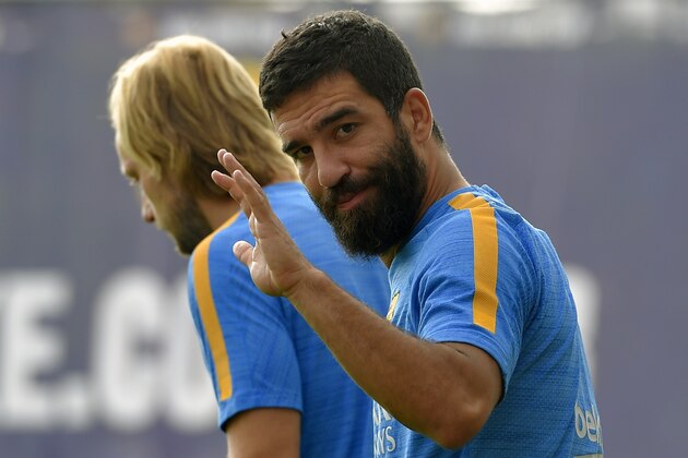 Barcelona's Turkish midfielder Arda Turan (R) arrives in a training session at the Sports Center FC Barcelona Joan Gamper in Sant Joan Despi, near Barcelona on July 31, 2015. AFP PHOTO/ LLUIS GENE        (Photo credit should read LLUIS GENE/AFP/Getty Images)