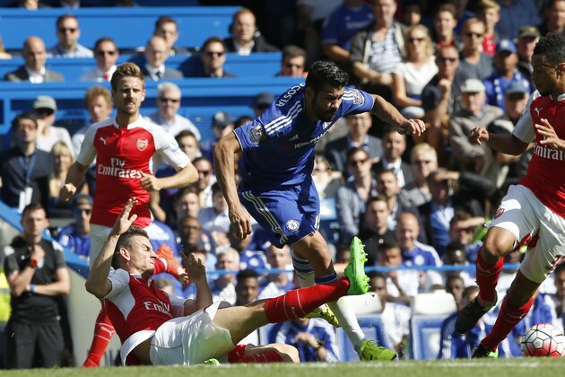 Chelsea's Diego Costa, centre is brought down and fouled by Arsenal's Laurent Koscielny during the English Premier League soccer match between Chelsea and Arsenal at Stamford Bridge stadium in London, Saturday, Sept. 19 2015. (AP Photo/Alastair Grant)
