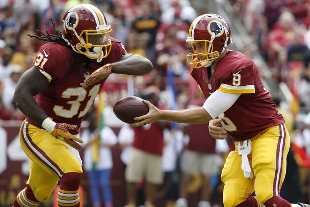 Washington Redskins quarterback Kirk Cousins (8) hands off to running back Matt Jones (31) during the first half of an NFL football game against the St. Louis Rams in Landover, Md., Sunday, Sept. 20, 2015. (AP Photo/Alex Brandon)