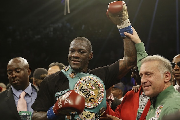 Deontay Wilder holds up his arm after he defeates Eric Molina during the WBC heavyweight boxing match, Saturday, June 13, 2015, in Birmingham, Ala. (AP Photo/Brynn Anderson)