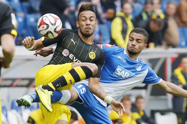 Hoffenheim's Jeremy Toljan, right, and Dortmund's Pierre-Emerick Aubameyang, left, challenge for the ball during a German first division Bundesliga soccer match between TSG 1899 Hoffenheim and Borussia Dortmund in Sinsheim, Germany, Saturday, May 2, 2015. (AP Photo/Michael Probst)