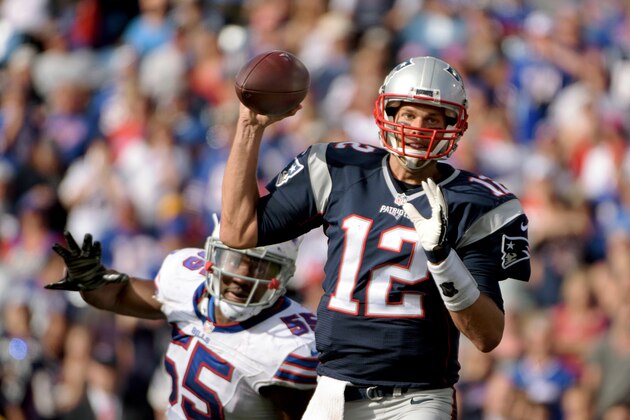 New England Patriots quarterback Tom Brady (12) throws under pressure by Buffalo Bills defensive end Jerry Hughes (55) during the second half of an NFL football game Sunday, Sept. 20, 2015, in Orchard Park, N.Y.  New England won 40-32. (AP Photo/Gary Wiepert)