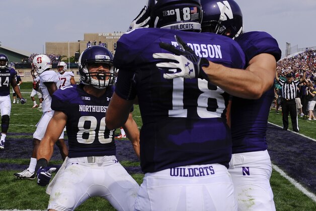 Northwestern quarterback Clayton Thorson (18) celebrates with Northwestern wide receiver Mike McHugh (6), right, and Northwestern wide receiver Austin Carr (80) after he ran for a touchdown against Stanford during the second quarter of an NCAA college football game in Evanston, Ill,  Saturday, Sept. 5, 2015. (AP Photo/Matt Marton