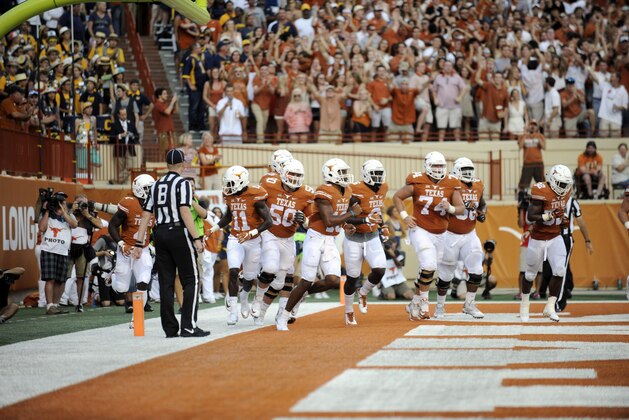 Sep 19, 2015; Austin, TX, USA; Texas Longhorns quarterback Jerrod Heard (13) and the Texas offense react against the California Golden Bears during the first quarter at Darrell K Royal-Texas Memorial Stadium. Mandatory Credit: Brendan Maloney-USA TODAY Sports