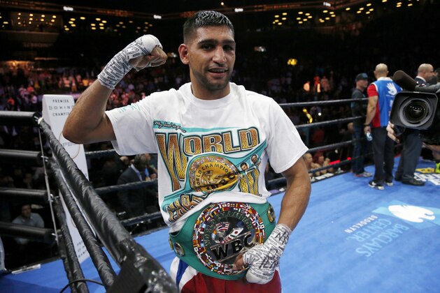 Amir Khan celebrates after defeating Chris Algieri during a boxing bout, Friday, May 29, 2015, in New York. Khan won by unanimous decision. (AP Photo/Julio Cortez)