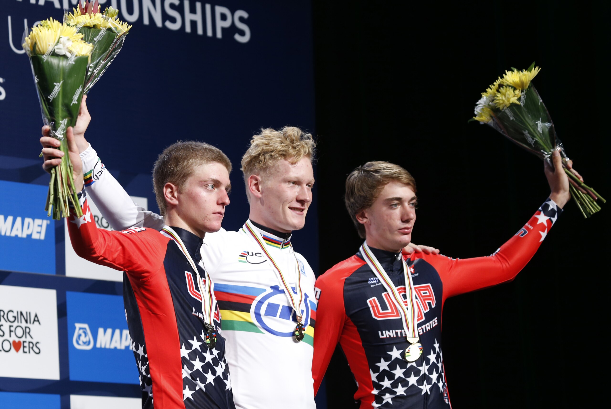Leo Appelt, center,of Germany, winner of the men's junior time trials, celebrates with second-place finisher Adrien Costa, left, of the United States, and third-place finisher Brandon McNulty, right, of the United States, during the award presentations at the UCI Road World Championships cycling races, Tuesday, Sept. 22, 2015, in Richmond, Va. (AP Photo/Steve Helber)
