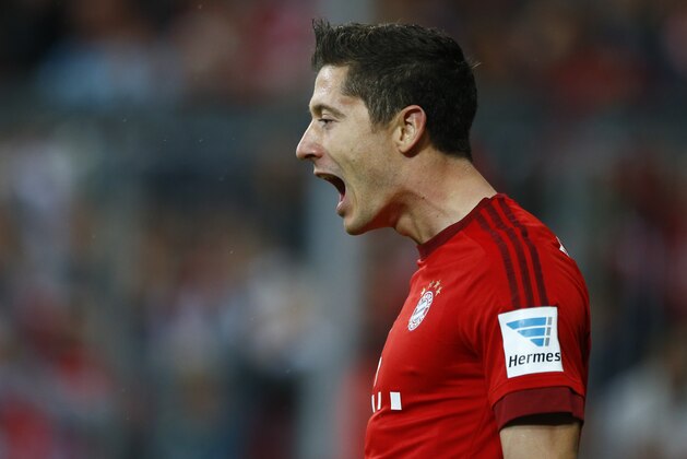 Bayern's Robert Lewandowski celebrates after scoring during the German Bundesliga soccer match between FC Bayern Munich and VfL Wolfsburg at the Allianz Arena stadium in Munich, Germany, Tuesday, Sept. 22, 2015. (AP Photo/Matthias Schrader)