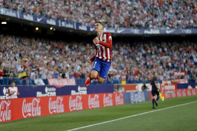 Atletico Madrid's Antoine Griezmann celebrates after scoring the opening goal against Getafe during a Spanish La Liga soccer match between Atletico Madrid and Getafe at the Vicente Calderon stadium in Madrid, Tuesday, Sept. 22, 2015. (AP Photo/Francisco Seco)