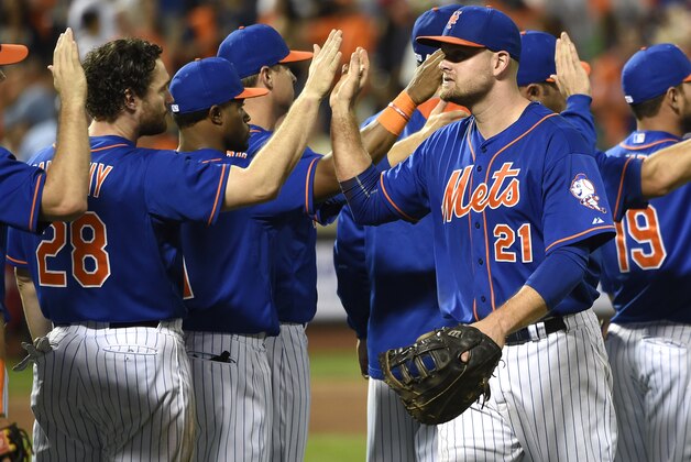 New York Mets' Daniel Murphy (28) and Lucas Duda (21) celebrate their 5-1 win over the New York Yankees in a baseball game with teammates, Friday, Sept. 18, 2015, in New York. Both Murphy and Duda hit home runs during the game. (AP Photo/Kathy Kmonicek)