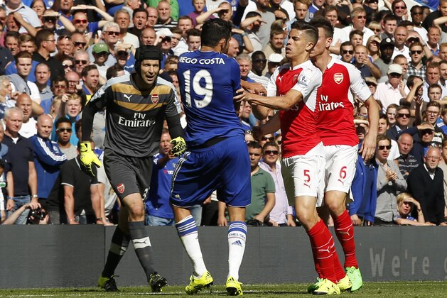 Arsenal's Gabriel, No 5, reacts and puts his arms onto Chelsea's Diego Costa, No 19, during the English Premier League soccer match between Chelsea and Arsenal at Stamford Bridge stadium in London, Saturday, Sept. 19, 2015. Both players were show a yellow card for the incident, with Gabriel being sent off for a further clash between the two player- Chelsea went onto win the game 2-0.(AP Photo/Alastair Grant)