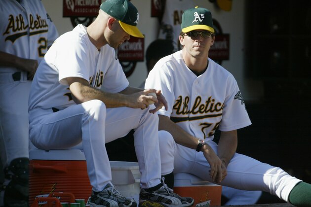 OAKLAND, CA - OCTOBER 6:  Tim Hudson #15 and Barry Zito #75 of the Oakland Athletics watch from the dugout during game five of the American League Western Division Series against the Minnesota Twins at Network Associates Coliseum on October 6, 2002 in Oakland, California.  The Twins defeated the A's 5-4.  (Photo by Jed Jacobsohn/Getty Images)