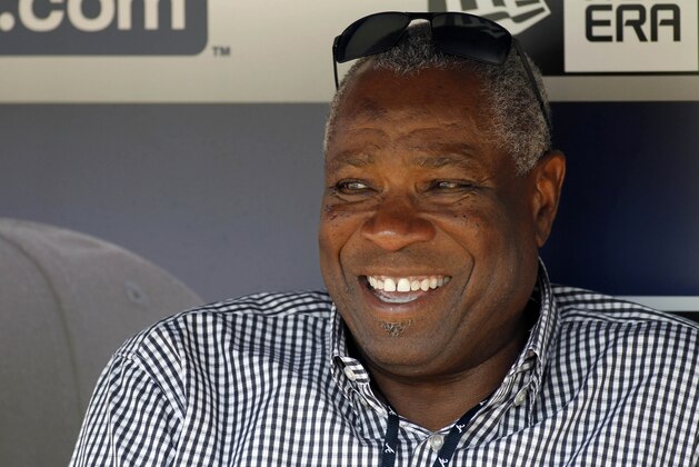 Former manager Dusty Baker sits in the Atlanta Braves dugout before a baseball game against the Miami Marlins, Friday, Aug. 7, 2015, in Atlanta. (AP Photo/Brett Davis)