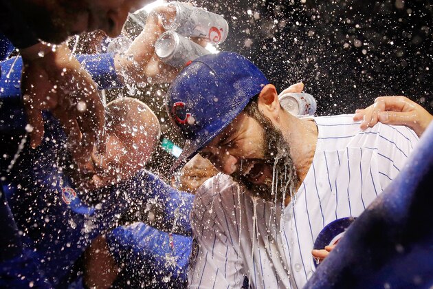 CHICAGO, IL - SEPTEMBER 22:  The Chicago Cubs celebrate with Jake Arrieta #49 on his 20th win of the season against the Milwaukee Brewers at Wrigley Field on September 22, 2015 in Chicago, Illinois. The Chicago Cubs won 4-0.  (Photo by Jon Durr/Getty Images)
