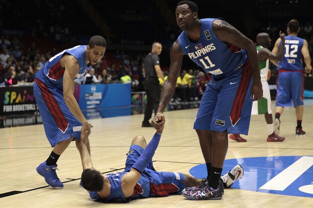 Philippines players Andray Blatche, right, and Gabe Norwood, left, help teammate Lewis Tenorio during the Group B Basketball World Cup match against Senegal in Seville, Spain, Thursday, Sept. 4, 2014. The 2014 Basketball World Cup competition will take place in various cities in Spain from Aug. 30 through to Sept. 14. (AP Photo/Miguel Angel Morenatti)