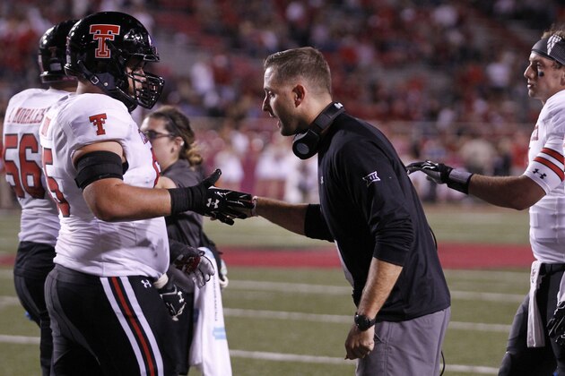 Texas Tech head coach Kliff Kingsbury congratulates offensive lineman Baylen Brown during the second half of an NCAA college football game against Arkansas, Saturday, Sept. 19, 2015, in Fayetteville, Ark. Texas Tech beat Arkansas 35-24. (AP Photo/Samantha Baker)