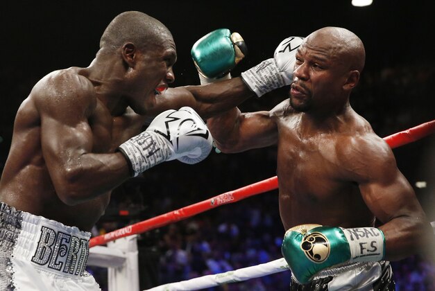 Floyd Mayweather Jr., right, fights Andre Berto during their welterweight title boxing bout Saturday, Sept. 12, 2015, in Las Vegas. (AP Photo/John Locher)