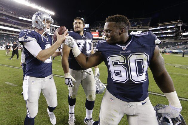 Dallas Cowboys' Brandon Weeden, left, celebrates with Davon Coleman, right, and Zack Martin after an NFL football game against the Dallas Cowboys, Sunday, Sept. 20, 2015, in Philadelphia. Dallas won 20-10. (AP Photo/Matt Rourke)