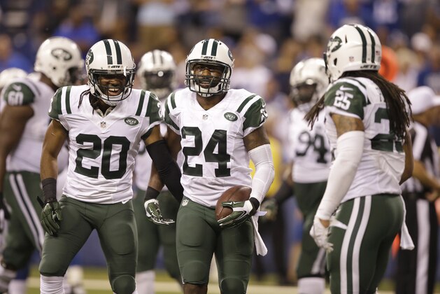 New York Jets cornerback Darrelle Revis (24) celebrates a fumble recovery with cornerback Marcus Williams (20) during the second half of an NFL football game against the Indianapolis Colts in Indianapolis, Monday, Sept. 21, 2015. (AP Photo/Darron Cummings)