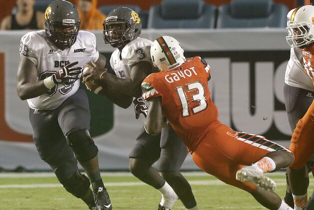 Miami linebacker Marques Gayot (13) sacks Bethune Cookman quarterback Quentin Williams (3) during an NCAA college football game, Saturday, Sept. 5, 2015, in Miami Gardens, Fla. (AP Photo/Alan Diaz)