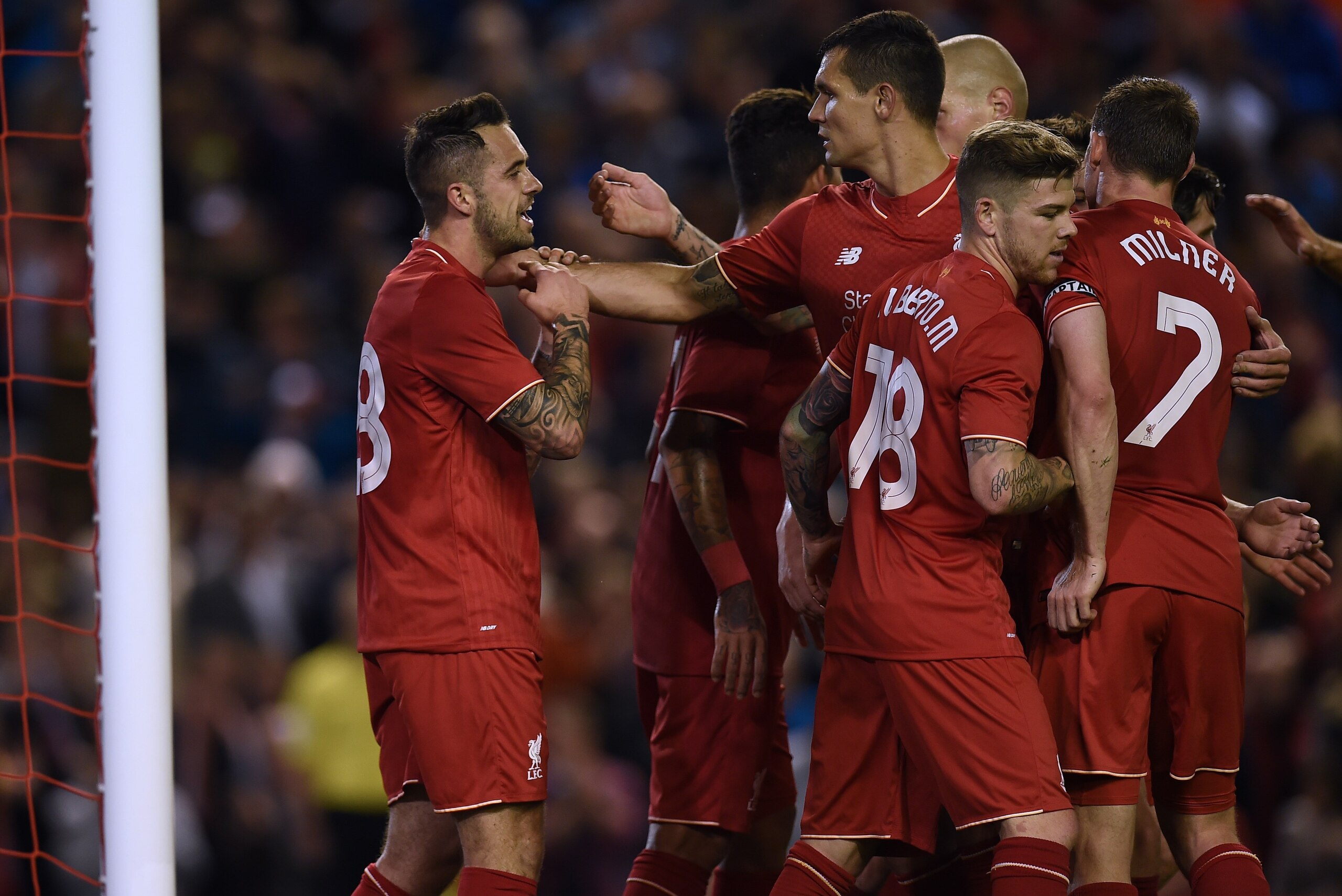 Liverpool's English striker Danny Ings (L) celebrates with teammates after scoring the opening goal of the English League Cup third round football match between Liverpool and Carlisle United at Anfield in Liverpool, north west England on September 23, 2015. AFP PHOTO / PAUL ELLIS

RESTRICTED TO EDITORIAL USE. No use with unauthorized audio, video, data, fixture lists, club/league logos or 'live' services. Online in-match use limited to 75 images, no video emulation. No use in betting, games or single club/league/player publications.        (Photo credit should read PAUL ELLIS/AFP/Getty Images)