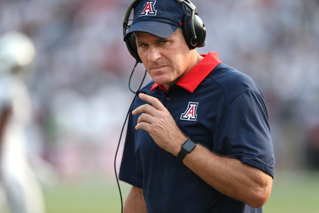 FILE- In this Sept. 12, 2015, file photo, Arizona coach Rich Rodriguez works the sidelines of an NCAA college football game against Nevada in Reno, Nev. The Wildcats won the tough Pac-12 South last year, but were swept by the LA teams, including a 17-7 loss that was the lowest scoring game of the season for coach Rich Rodrguez’s high-scoring team.  (AP Photo/Cathleen Allison, File)