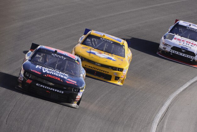 Jeremy Clements (51) John Wes Townley (25) and Ryan Blaney (22) drive their cars during the NASCAR Xfinity Series auto race at Chicagoland Speedway, Saturday, Sept. 19, 2015, in Joliet, Ill. (AP Photo/Matt Marton)