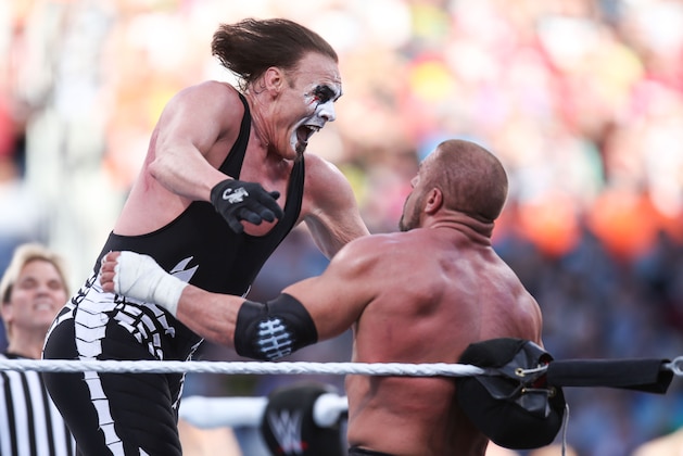 WWE wrester Sting attacks his opponent Triple H at Wrestlemania XXXI, on Sunday, March 29, 2015 in Santa Clara, CA. 2015 marks the first year Wrestlemania will be held in the San Francisco Bay Area, being made available to viewers in 177 countries via the WWE Network. (Don Feria/AP Images for WWE)