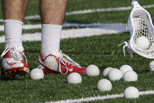 In this photo taken on Monday, May 5, 2014, University of Richmond men's Lacrosse player gathers balls during lacrosse practice in Richmond, Va. Richmond's first season playing Division I men's lacrosse started with five consecutive losses. It will end in the NCAA tournament.(AP Photo/Steve Helber)