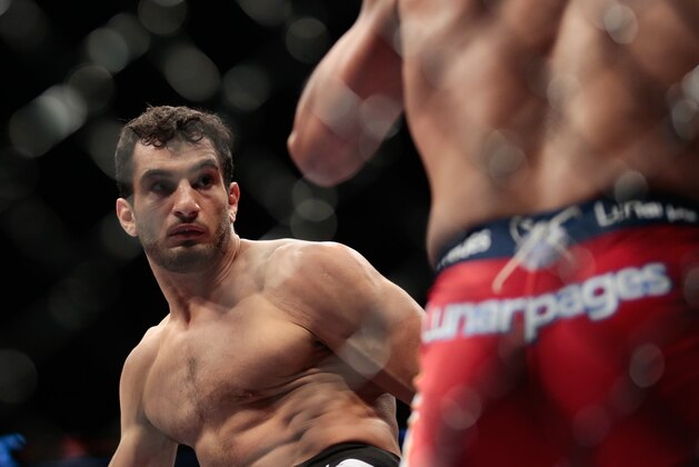 Iranian born Gegard Mousasi, right, fights Mark Munoz from the United States in a middleweight fight during the UFC Fight Night mixed martial arts event in Berlin, Saturday, May 31, 2014.  Gegard Mousasi won the fight. (AP Photo/Markus Schreiber)