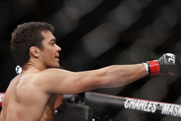 Lyoto Machida, from Brazil, celebrates after defeating CB Dollaway, from the United States, during their UFC middleweight mixed martial arts bout in Barueri, on the outskirts of Sao Paulo, Brazil, early Sunday, Dec. 21, 2014. (AP Photo/Andre Penner)