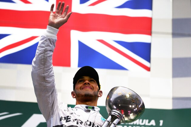 SUZUKA, JAPAN - OCTOBER 05:  Lewis Hamilton of Great Britain and Mercedes GP celebrates following his victory during the Japanese Formula One Grand Prix at Suzuka Circuit on October 5, 2014 in Suzuka, Japan.  (Photo by Clive Mason/Getty Images)