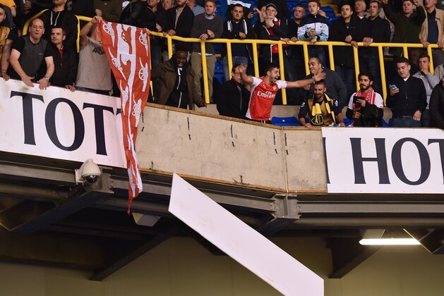 Supporters dismantle the large 'Tottenham Hotspur' sign inside the stadium after the English League Cup third round football match between Tottenham Hotspur and Arsenal at White Hart Lane in north London on September 23, 2015. Mathieu Flamini scored both goals as Arsenal beat Tottenham 2-1. AFP PHOTO / BEN STANSALL

RESTRICTED TO EDITORIAL USE. No use with unauthorized audio, video, data, fixture lists, club/league logos or 'live' services. Online in-match use limited to 75 images, no video emulation. No use in betting, games or single club/league/player publications.        (Photo credit should read BEN STANSALL/AFP/Getty Images)