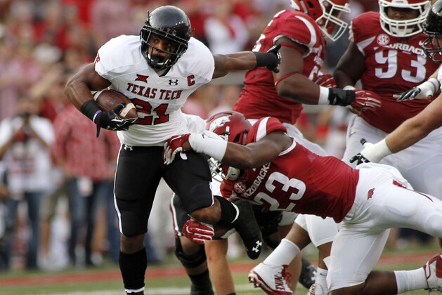 Arkansas' Dre Greenlaw (23) grabs Texas Tech's DeAndre Washington (21) during the first half of an NCAA college football game in Fayetteville, Ark., Saturday, Sept. 19, 2015. (AP Photo/Samantha Baker)