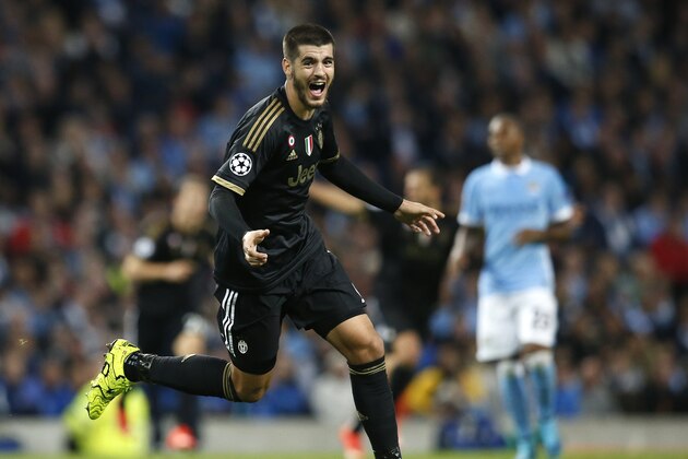Juventus' Alvaro Morata celebrates after scoring his sides second goal during the Champions League group D soccer match between Manchester City and Juventus at the Etihad Stadium, Manchester, England, Tuesday, Sept. 15, 2015. (AP Photo/Jon Super)