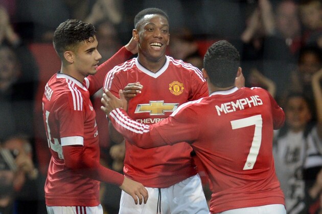 Manchester United's French midfielder Anthony Martial celebrates with Manchester United's Belgian midfielder Andreas Pereira (L) and Manchester United's Dutch midfielder Memphis Depay (R) after scoring their third goal during the English League Cup third round football match between Manchester United and Ipswich Town at Old Trafford in Manchester, north west England on September 23, 2015. Manchester United won the game 3-0. AFP PHOTO / OLI SCARFF

RESTRICTED TO EDITORIAL USE. No use with unauthorized audio, video, data, fixture lists, club/league logos or 'live' services. Online in-match use limited to 75 images, no video emulation. No use in betting, games or single club/league/player publications.        (Photo credit should read OLI SCARFF/AFP/Getty Images)
