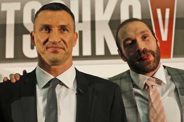 WBA, WBO, IBF, and IBO heavyweight boxer, Wladimir Klitschko, left, and British heavyweight Tyson Fury pose for photographers during a press conference for their heavyweight title bout on October 24, 2015 in Duesseldorf, Germany, in London, Wednesday, Sept. 23, 2015.(AP Photo/Frank Augstein)