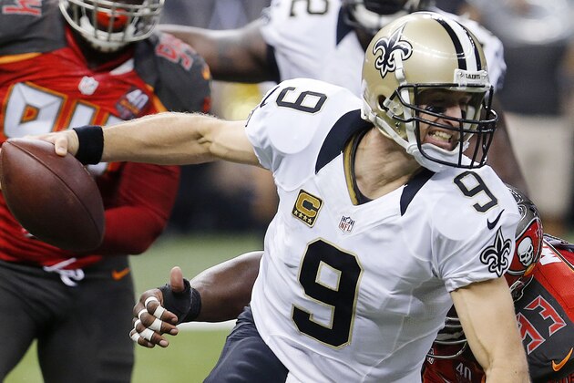 New Orleans Saints quarterback Drew Brees (9) is wrapped up by Tampa Bay Buccaneers defensive tackle Gerald McCoy (93) as he scrambles in the first half of an NFL football game against the Tampa Bay Buccaneers in New Orleans, Sunday, Sept. 20, 2015. The Buccaneers won 26-19. The Buccaneers won 26-19. (AP Photo/Bill Haber)