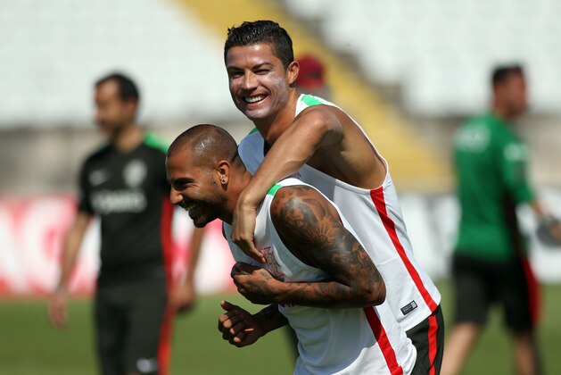 Cristiano Ronaldo, right, jokes with his teammate Ricardo Quaresma during a Portugal national soccer team training session at the National Stadium in Oeiras, near Lisbon, Friday, June 5, 2015. Portugal will play against Armenia a Euro 2016 Group I qualifying round soccer match on June 13. (AP Photo/Francisco Seco)