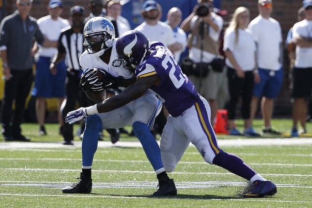 Detroit Lions wide receiver Calvin Johnson (81) catches a pass as Minnesota Vikings cornerback Xavier Rhodes (29) defends in the second half of an NFL football game in Minneapolis, Sunday, Sept. 20, 2015. (AP Photo/Ann Heisenfelt)