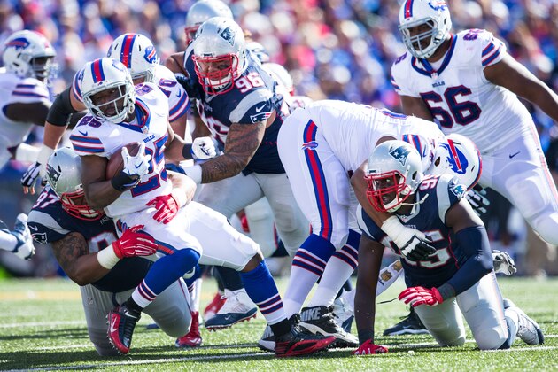 ORCHARD PARK, NY - SEPTEMBER 20:  Alan Branch #97 of the New England Patriots tackles LeSean McCoy #25 of the Buffalo Bills during the second half on September 20, 2015 at Ralph Wilson Stadium in Orchard Park, New York.  New England defeats Buffalo 40-32.  (Photo by Brett Carlsen/Getty Images)